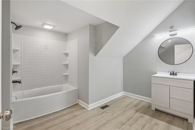 bathroom with vanity, wood-type flooring, and shower / tub combination