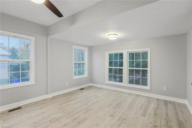 empty room with light hardwood / wood-style flooring and ceiling fan