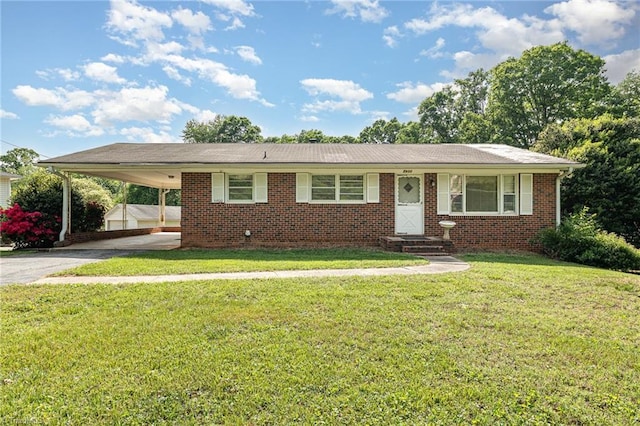 view of front facade with a front yard, brick siding, entry steps, driveway, and a carport