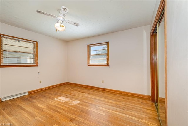 unfurnished bedroom with visible vents, light wood-style flooring, baseboards, and a closet