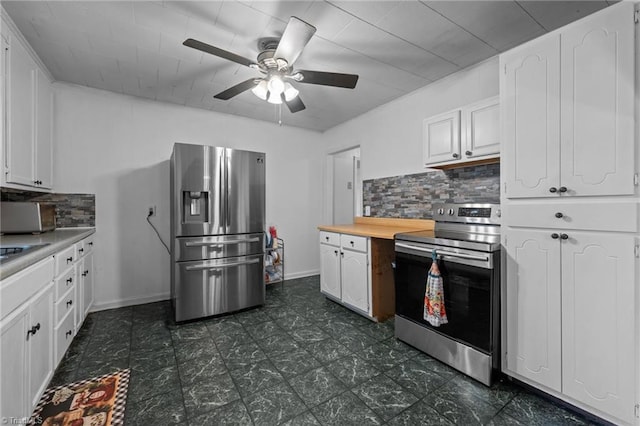 2719 NC Highway 87, Graham, NC 27253 - kitchen with stainless steel appliances, white cabinetry, tasteful backsplash, and a ceiling fan