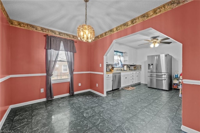 2719 NC Highway 87, Graham, NC 27253 - kitchen featuring appliances with stainless steel finishes, a chandelier, white cabinets, baseboards, and light countertops