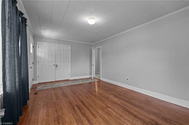 2719 NC Highway 87, Graham, NC 27253 - unfurnished bedroom featuring wood finished floors, crown molding, baseboards, and a closet