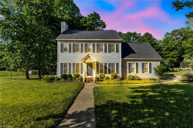 colonial house featuring a chimney