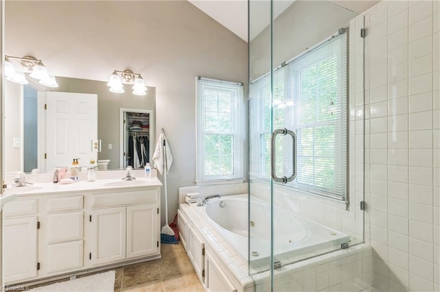 full bath with tile patterned flooring, double vanity, a tub with jets, vaulted ceiling, and a shower stall
