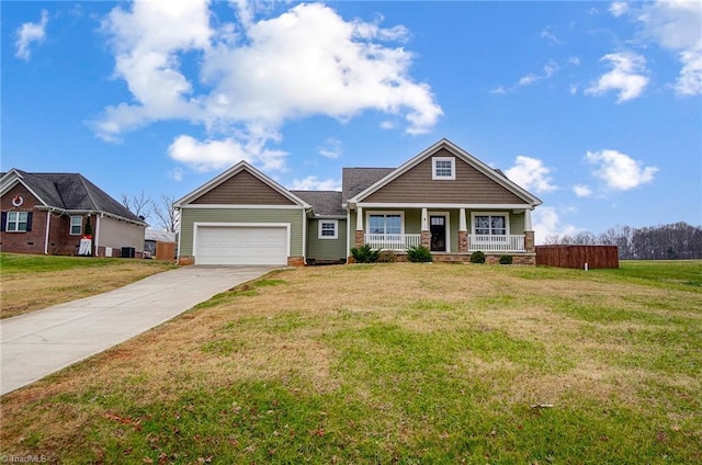 craftsman inspired home with a porch, a garage, and a front lawn