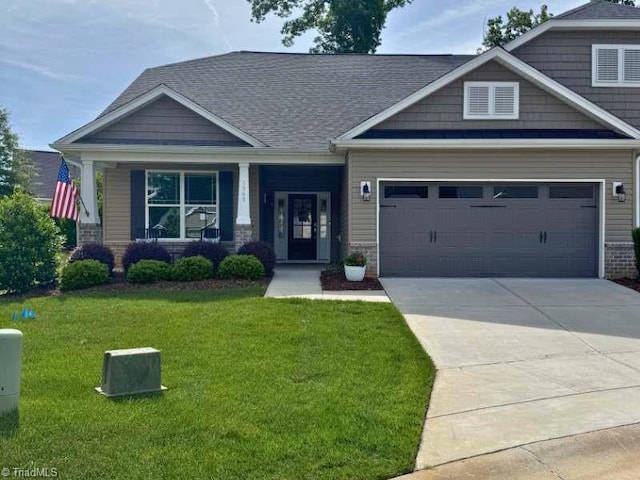 craftsman-style house featuring concrete driveway, a garage, a front lawn, and a porch