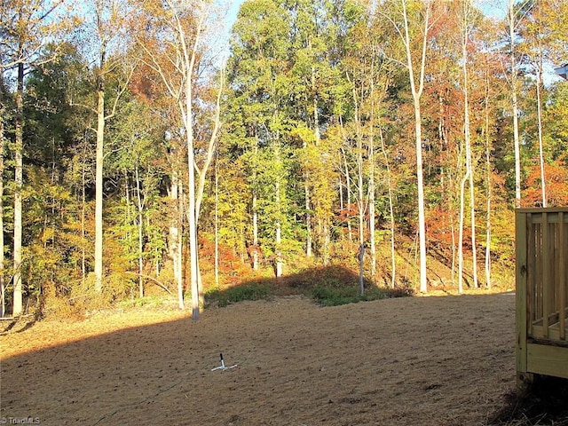 view of yard featuring a forest view