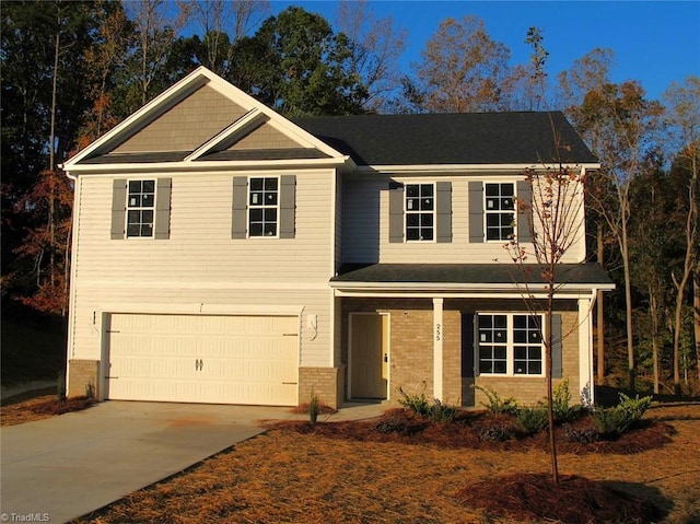 craftsman house featuring a garage, concrete driveway, and brick siding