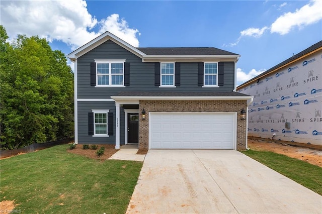 4196 Emmas Way E, Bend, NC 27018 - view of front of home with an attached garage, brick siding, driveway, and a front yard