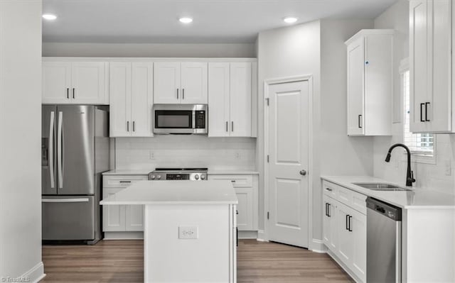 4196 Emmas Way E, Bend, NC 27018 - kitchen with appliances with stainless steel finishes, a sink, backsplash, light wood-style floors, and recessed lighting