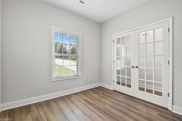 4196 Emmas Way E, Bend, NC 27018 - spare room with french doors, wood finished floors, and baseboards