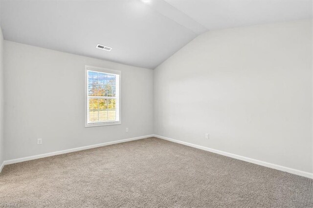 4196 Emmas Way E, Bend, NC 27018 - carpeted spare room featuring lofted ceiling and baseboards