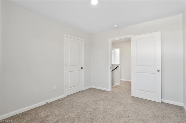 4196 Emmas Way E, Bend, NC 27018 - unfurnished bedroom featuring light carpet and baseboards