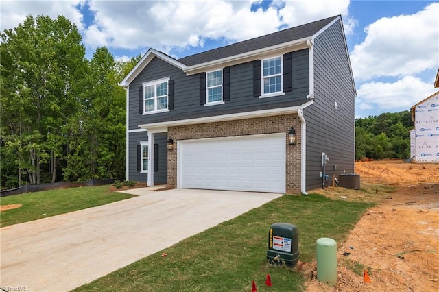 4196 Emmas Way E, Bend, NC 27018 - view of front facade with a garage, driveway, central AC unit, brick siding, and a front lawn