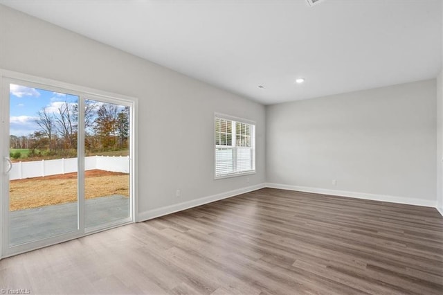 4196 Emmas Way E, Bend, NC 27018 - empty room with wood finished floors, baseboards, and recessed lighting