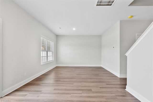 4196 Emmas Way E, Bend, NC 27018 - unfurnished room with baseboards, wood finished floors, recessed lighting, and a smoke detector
