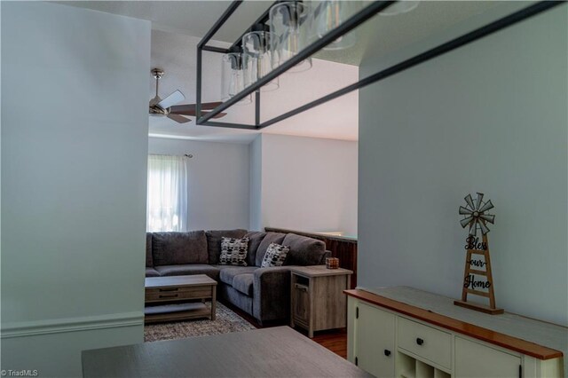 living area with ceiling fan and wood finished floors