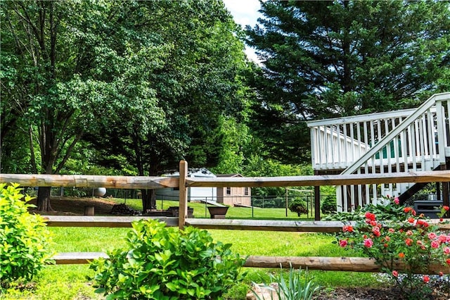 view of yard featuring stairs and a wooden deck