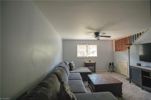 living room featuring light colored carpet and ceiling fan