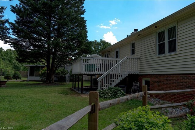 view of yard featuring a wooden deck and stairway