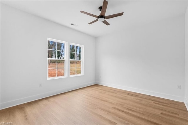 spare room with ceiling fan and light wood-type flooring