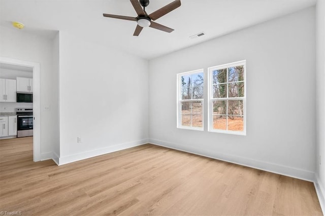 unfurnished room featuring ceiling fan and light wood-type flooring