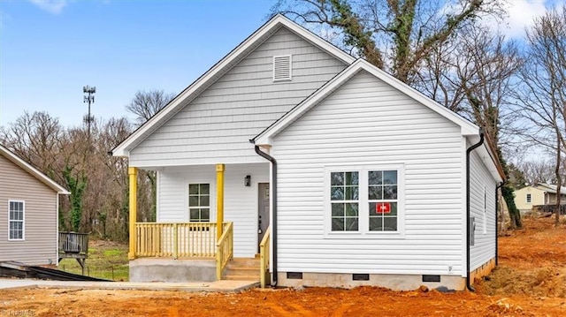 back of house featuring covered porch