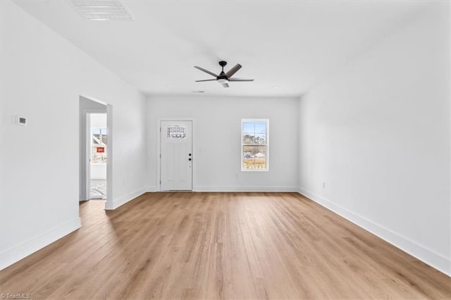 spare room featuring ceiling fan and light wood-type flooring