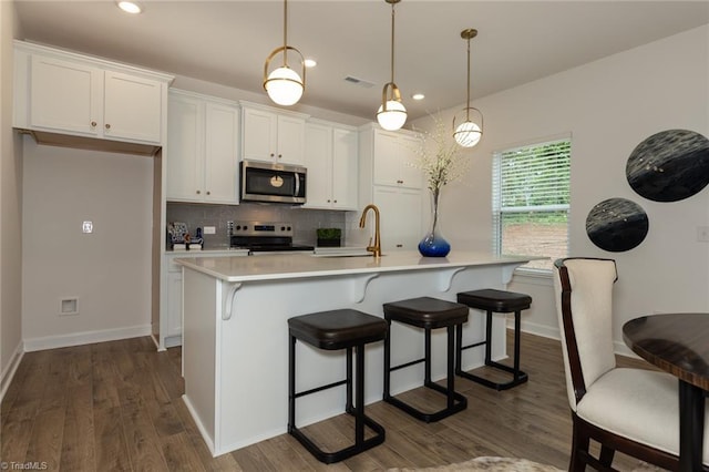 6005 Crestridge Ln Unit 1005, Winston-Salem, NC 27105 - kitchen with appliances with stainless steel finishes, tasteful backsplash, white cabinetry, dark wood-style floors, and light countertops