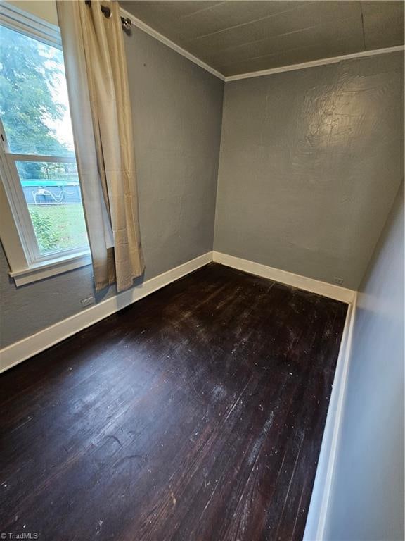 unfurnished room with ornamental molding, plenty of natural light, and hardwood / wood-style floors