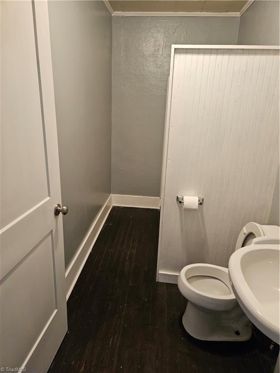 bathroom featuring hardwood / wood-style floors, ornamental molding, toilet, and sink