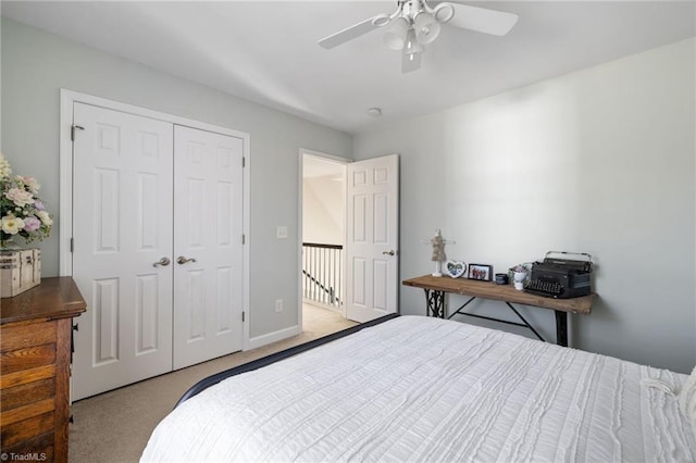 bedroom with a closet, baseboards, a ceiling fan, and carpet floors