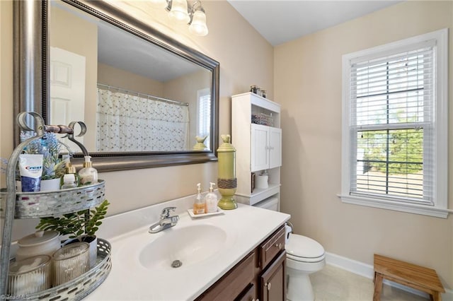 bathroom featuring vanity, a shower with curtain, baseboards, tile patterned flooring, and toilet