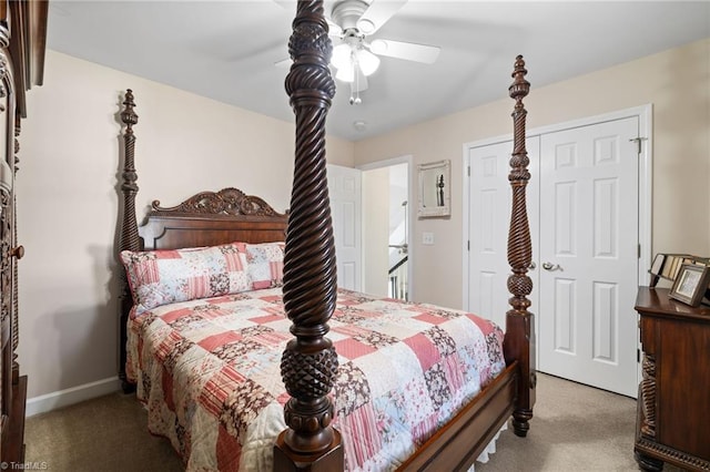 bedroom featuring a ceiling fan, light colored carpet, a closet, and baseboards