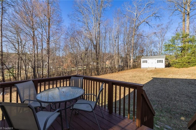 wooden deck with an outbuilding and outdoor dining area