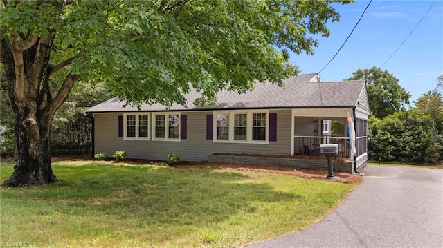 2826 Westridge Rd, Winston-Salem, NC 27103 - ranch-style house featuring a front lawn, asphalt driveway, roof with shingles, and a porch