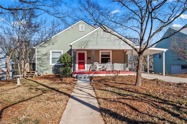 bungalow with a porch and a front yard