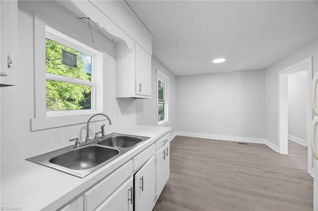 220 Glen Ter, Mount Airy, NC 27030 - kitchen featuring white cabinetry, light countertops, a sink, baseboards, and light wood finished floors