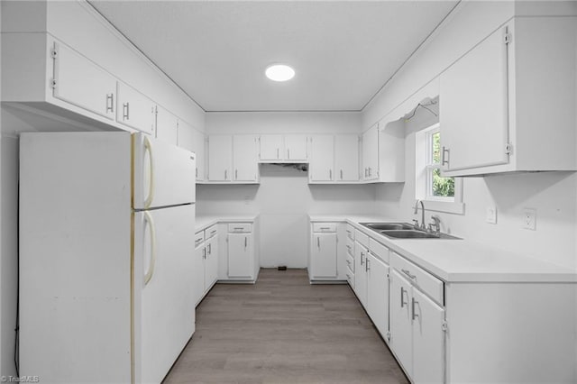 220 Glen Ter, Mount Airy, NC 27030 - kitchen with freestanding refrigerator, a sink, light wood-type flooring, white cabinetry, and light countertops