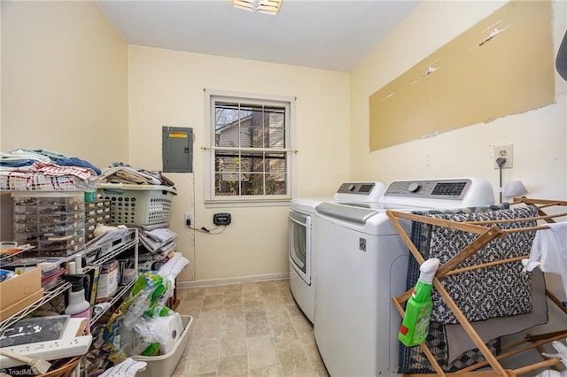 clothes washing area with separate washer and dryer and electric panel