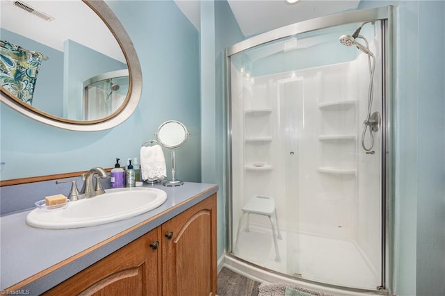 bathroom with vanity, wood-type flooring, and a shower with shower door