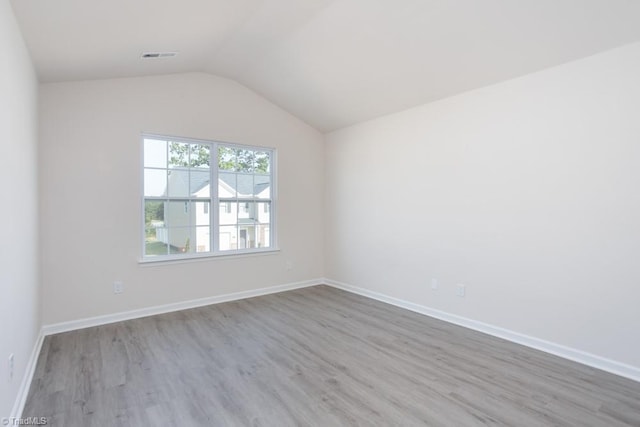 5504 Avery Dr, Trinity, NC 27370 - unfurnished room with wood finished floors, vaulted ceiling, and baseboards