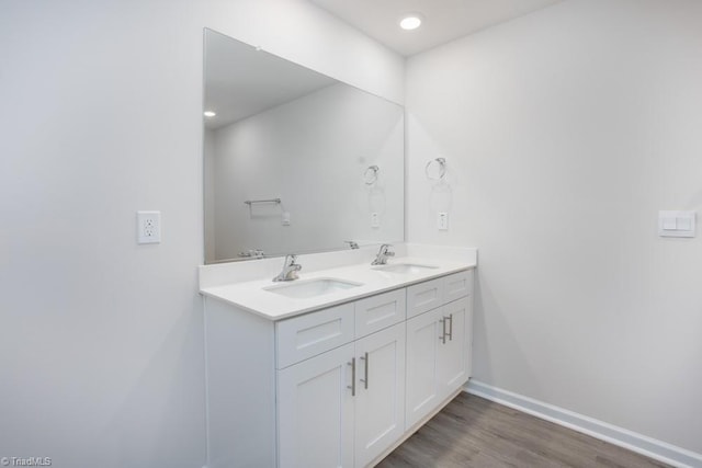5504 Avery Dr, Trinity, NC 27370 - bathroom featuring double vanity, wood finished floors, baseboards, and recessed lighting