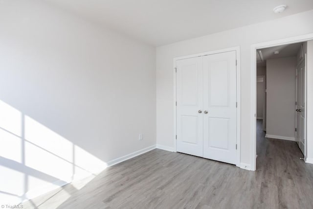 5504 Avery Dr, Trinity, NC 27370 - unfurnished bedroom with wood finished floors, baseboards, and a closet