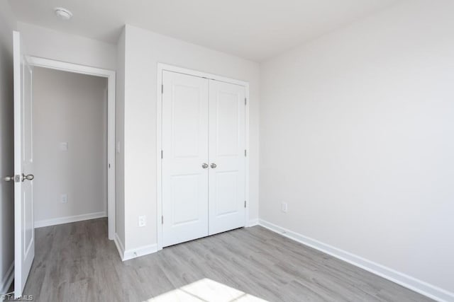 5504 Avery Dr, Trinity, NC 27370 - unfurnished bedroom with wood finished floors, a closet, and baseboards