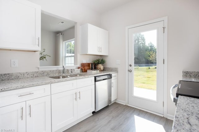 5504 Avery Dr, Trinity, NC 27370 - kitchen with stainless steel dishwasher, a sink, light wood-style flooring, white cabinets, and light stone counters