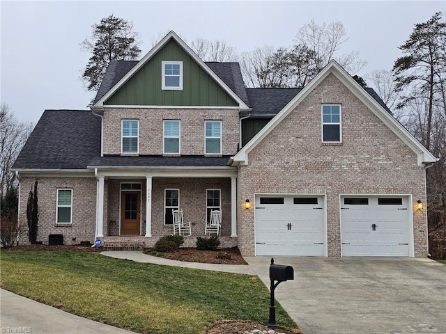 craftsman inspired home featuring driveway, covered porch, a shingled roof, a front lawn, and board and batten siding