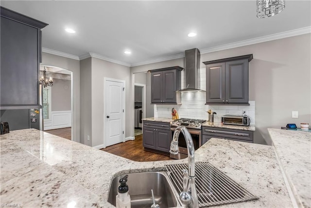 3632 Sally Kirk Rd, Winston-Salem, NC 27106 - kitchen with wall chimney exhaust hood, gas stove, tasteful backsplash, dark wood finished floors, and crown molding