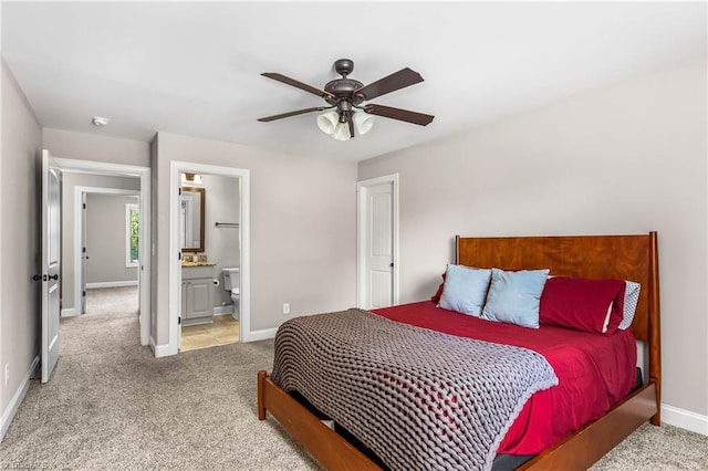 3632 Sally Kirk Rd, Winston-Salem, NC 27106 - carpeted bedroom featuring baseboards, connected bathroom, and a ceiling fan